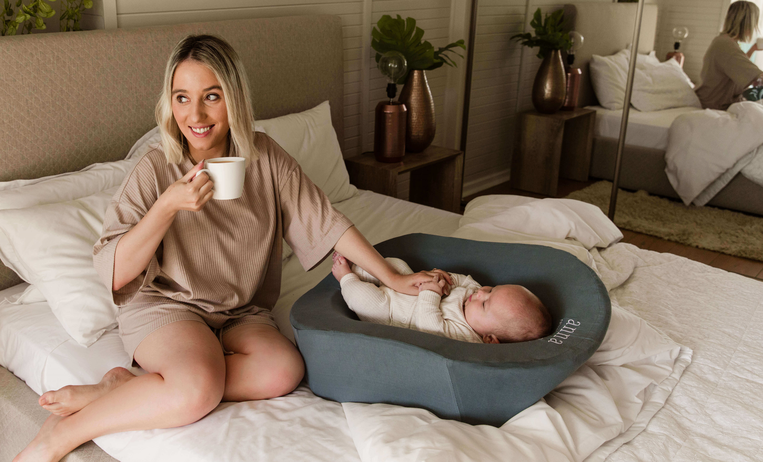 https://natalcomfort.com/cdn/shop/files/women_cooing_her_baby_who_is_lying_in_Anna_Pregnancy_Pillow_on_a_bed.png?v=1661345686&width=1500
